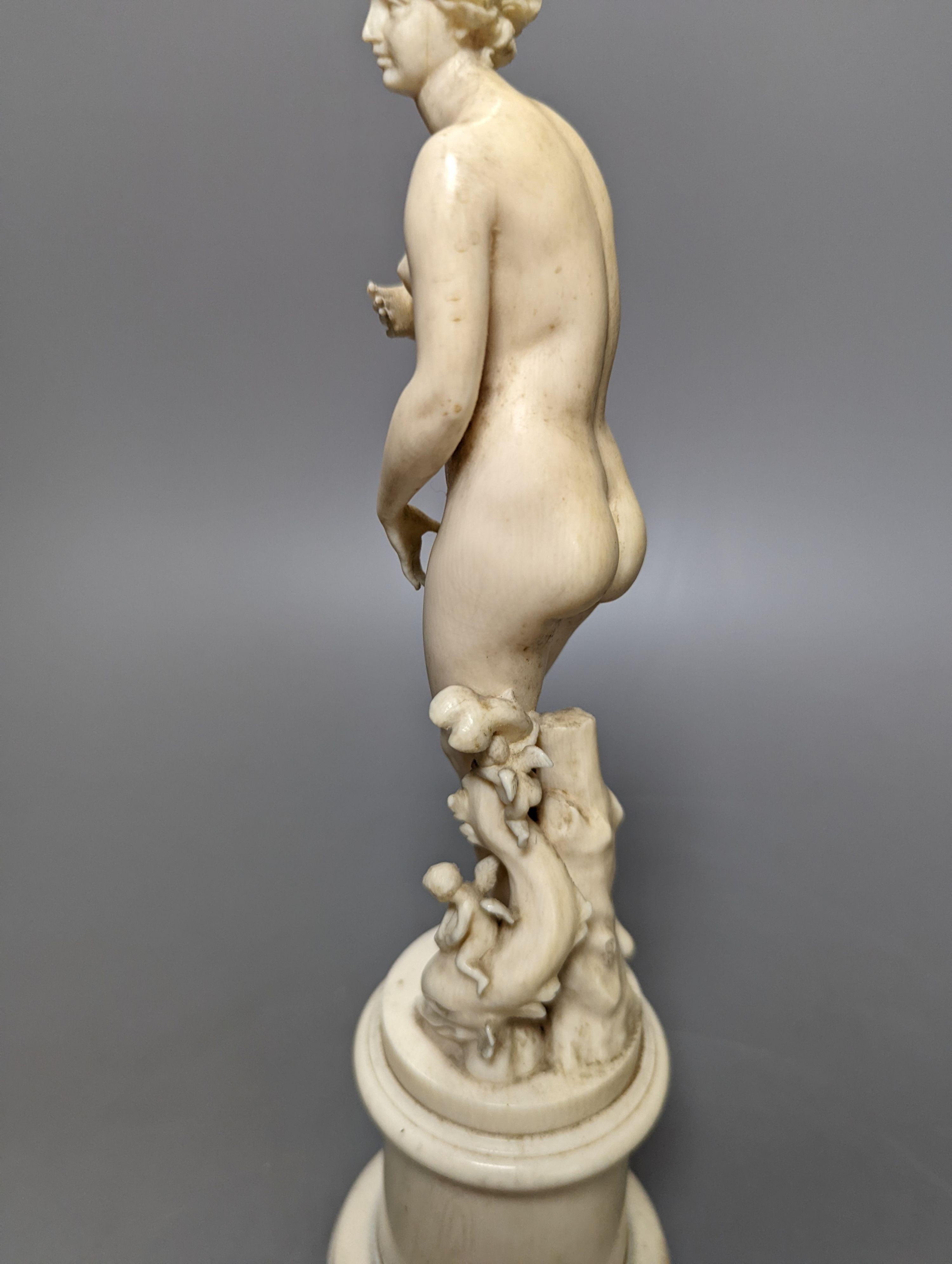 A 19th century Dieppe ivory figure after the antique ‘Venus with dolphin’ 25cm